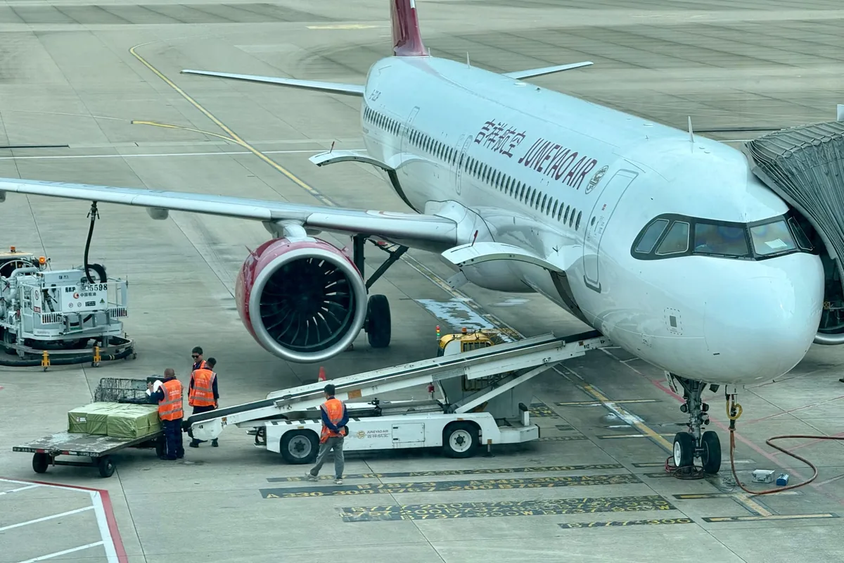 Cargo aircraft being loaded at an airport terminal